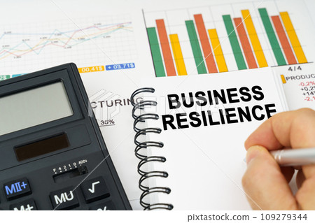 There is a calculator on the table, business charts, a man made a note in a notebook - business resilience There is a calculator on the table, business charts, a man made a note in a notebook - business resilience 109279344