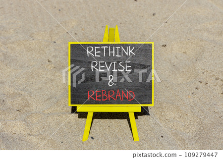 Rethink revise rebrand symbol. Concept word Rethink Revise and Rebrand on beautiful blackboard. Beautiful sand beach background. Business brand motivational rethink revise rebrand concept. Copy space. 109279447