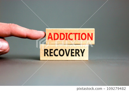 Addiction recovery symbol. Concept words Addiction recovery on beautiful wooden blocks. Beautiful grey table grey background. Businessman hand. Psychology addiction recovery concept. Copy space. Addiction recovery symbol. Concept words Addiction recovery on beautiful wooden blocks. Beautiful grey table grey background. Businessman hand. Psychology addiction recovery concept. Copy space. 109279482