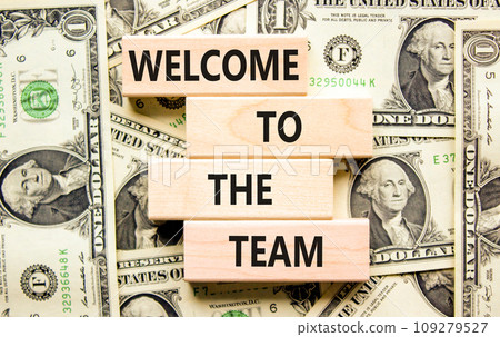 Welcome to the team symbol. Concept words Welcome to the team on wooden block. Dollar bills. Beautiful background from dollar bills. Business, motivational and welcome to the team concept. 109279527
