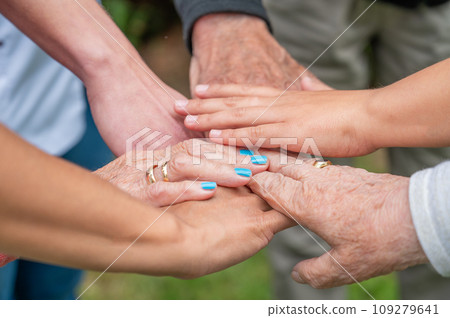 Concept of family, aging society or teamwork, hands showing unity with putting hands together 109279641