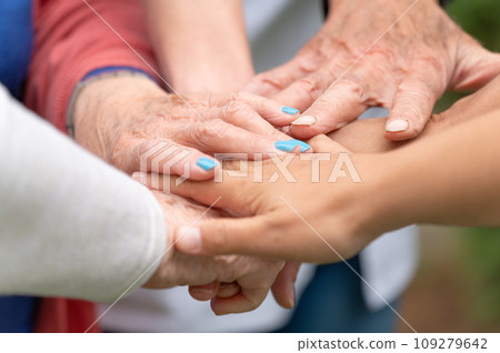 Concept of family, aging society or teamwork, hands showing unity with putting hands together Concept of family, aging society or teamwork, hands showing unity with putting hands together 109279642