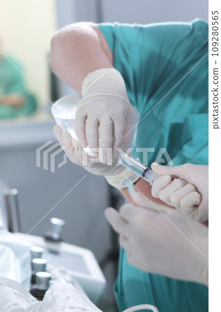 Preparation of the injection. Syringe in hands of doctors. Operating unit. Unrecognizable persons. Modern surgery. Vertical photo. Preparation of the injection. Syringe in hands of doctors. Operating unit. Unrecognizable persons. Modern surgery. Vertical photo. 109280565