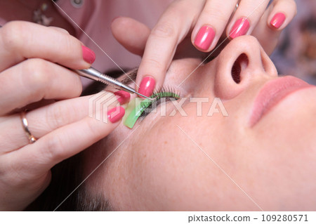 Coloring and curling of eyelashes. Lamination of eyelashes. Eyelash care procedures.Eyelash extension for a girl in a beauty salon. Concept of beauty. Coloring and curling of eyelashes. Lamination of eyelashes. Eyelash care procedures.Eyelash extension for a girl in a beauty salon. Concept of beauty. 109280571
