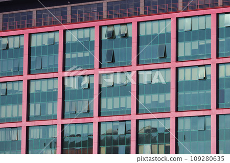 Multiple closed windows on a large office building. 109280635