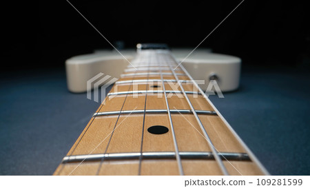 Macro of strings on electric guitar fretboard. Details of instrument close-up Macro of strings on electric guitar fretboard. Details of instrument close-up 109281599