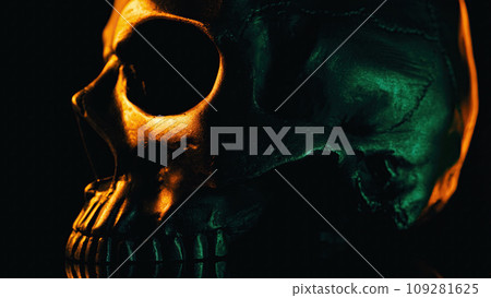 Bronze human skull rotates on black background. Exploring death, gothic theme. Bronze human skull rotates on black background. Exploring death, gothic theme. 109281625