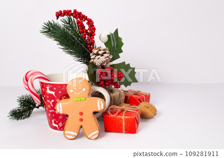 Gingerbread men, cup, Christmas trees, pine cone, nut on white background 109281911
