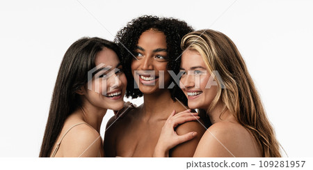 Female models of different ages celebrating their natural bodies in a studio. Three confident and happy women smiling cheerfully. Women standing together against a studio background. Female models of different ages celebrating their natural bodies in a studio. Three confident and happy women smiling cheerfully. Women standing together against a studio background. 109281957