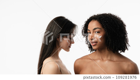 Female models of various ages celebrating their natural bodies in a studio. Two confident and joyful women smiling radiantly, having used cosmetics. Female models of various ages celebrating their natural bodies in a studio. Two confident and joyful women smiling radiantly, having used cosmetics. 109281976