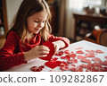 Kid making heart-shaped Valentine's card 109282867