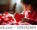 Kid making heart-shaped Valentine's card 109282869
