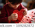 Kid making heart-shaped Valentine's card 109282872