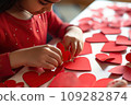 Kid making heart-shaped Valentine's card 109282874