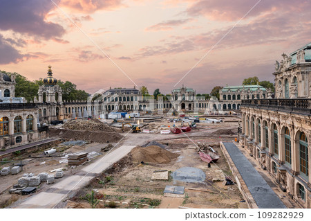 Dresden Zwinger palace king inner courtyard under reconstruction and renovation with dramatic sunset sky background. German architecture landmark building garden repair landscaping 109282929