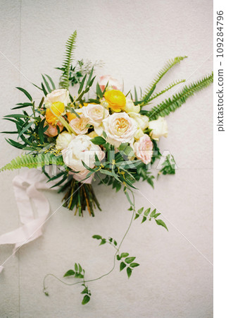 Bridal bouquet lies on a white tile. Top view 109284796