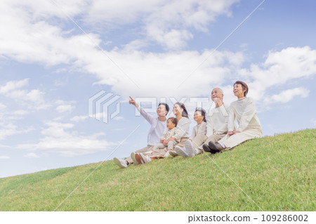 Three generation family sitting on the bank / Three generation family 109286002