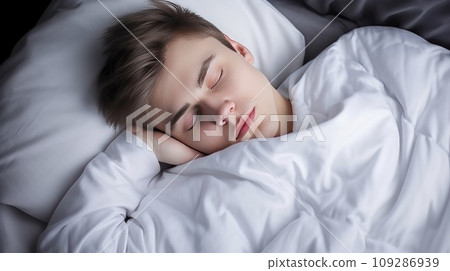 Young Caucasian man sleeps under warm plaid on soft bed at home closeup Young Caucasian man sleeps under warm plaid on soft bed at home closeup 109286939