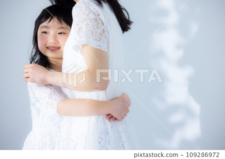 Girl hugging her mother Girl hugging her mother 109286972