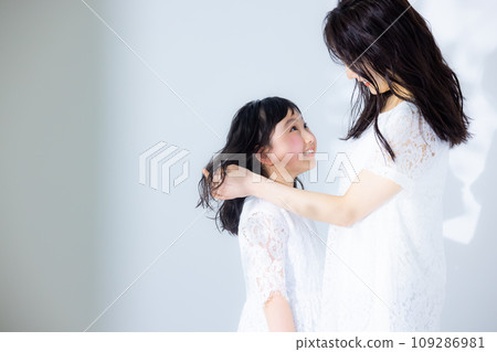 Girl hugging her mother Girl hugging her mother 109286981