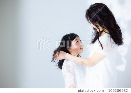 Girl hugging her mother Girl hugging her mother 109286982