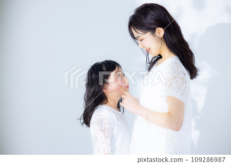 Girl hugging her mother Girl hugging her mother 109286987