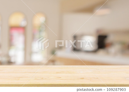 Empty wood table top with cafe restaurant interior blur background 109287903