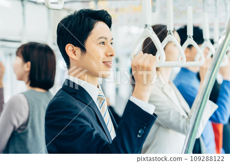 Businessman on a commuter train Photography cooperation: Keio Electric Railway Co., Ltd. Businessman on a commuter train Photography cooperation: Keio Electric Railway Co., Ltd. 109288122