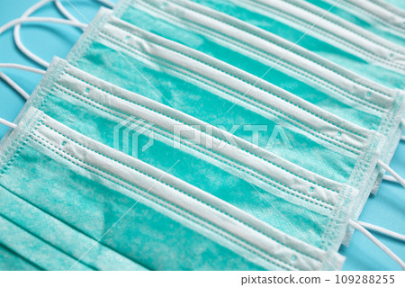 Surgical face mask on blue background protection against COVID-19 coronavirus. Healthcare and medical concept 109288255