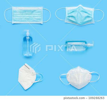 N95 Medical face mask with alcohol sanitizer gel hand wash bottle on blue background covid-19 Coronavirus prevention concept minimal flat lay style 109288263