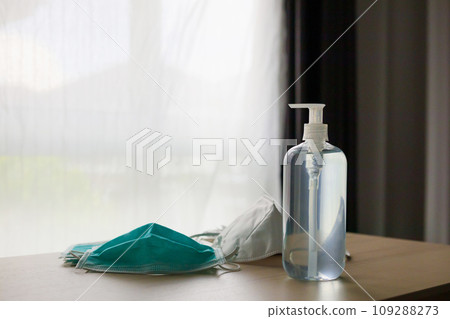 Medical face mask with alcohol sanitizer gel hand wash on wood table for covid-19 Coronavirus prevention concept Medical face mask with alcohol sanitizer gel hand wash on wood table for covid-19 Coronavirus prevention concept 109288273