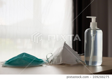 Medical face mask with alcohol sanitizer gel hand wash on wood table for covid-19 Coronavirus prevention concept 109288275