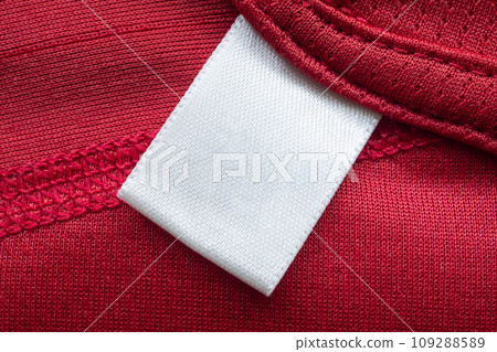 White blank laundry care clothes label on red polyester sport shirt background White blank laundry care clothes label on red polyester sport shirt background 109288589