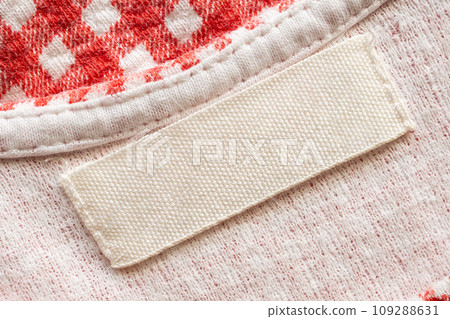 White blank laundry care clothes label on cotton shirt background White blank laundry care clothes label on cotton shirt background 109288631