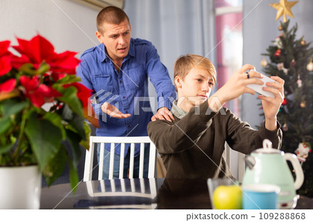 Father is unhappy with his son and expresses his displeasure during holiday of christmas 109288868