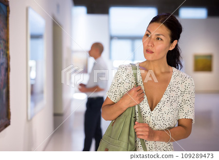 woman admiring art work 109289473