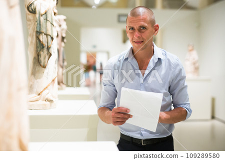 Man standing in museum hall 109289580