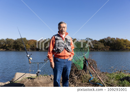 A man enjoying fishing in the river A man enjoying fishing in the river 109291001