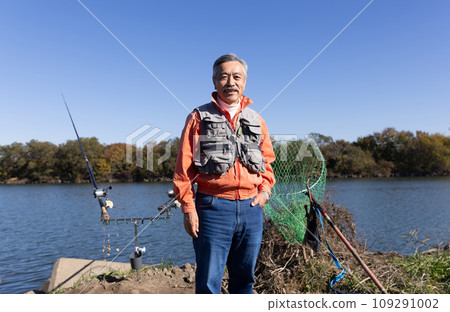 A man enjoying fishing in the river A man enjoying fishing in the river 109291002