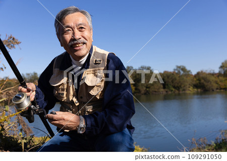 A man enjoying fishing in the river A man enjoying fishing in the river 109291050