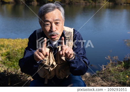 A man enjoying fishing in the river A man enjoying fishing in the river 109291051