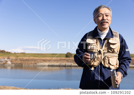 A man enjoying fishing in the river A man enjoying fishing in the river 109291102