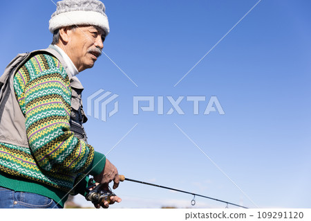 A man enjoying fishing in the river A man enjoying fishing in the river 109291120