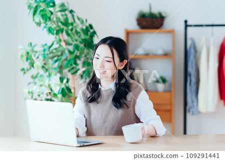 A young woman relaxing in the living room. 109291441