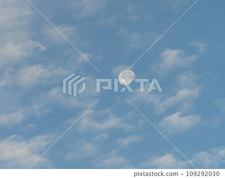 Moon floating in the early morning sky 109292030