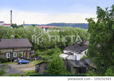 Backyard of a street with wooden houses, sheds and trees in the town of Sortavala in Karelia 109292985