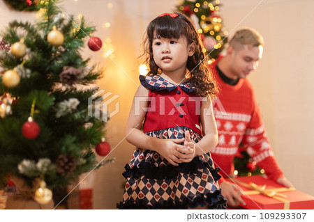 Little cute girl with christmas tree at home. Christmas day concept. child female celebration eve. Little cute girl with christmas tree at home. Christmas day concept. child female celebration eve. 109293307