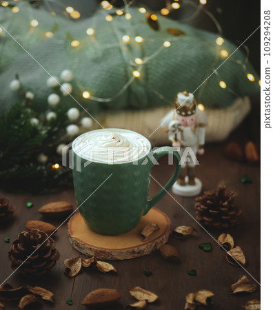 Coffee mug with coffee with cream.A festive photo with a Christmas mood. Cinnamon in a cup 109294208