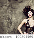 Female model posing in front of a wall 109294569