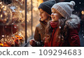 Two small children a boy and a girl on a snowy winter street are looking at a shop window 109294683